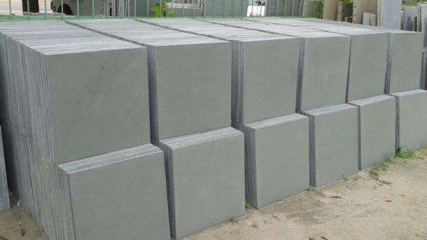 Stacks of polished Kota stone tiles arranged for delivery and installation.